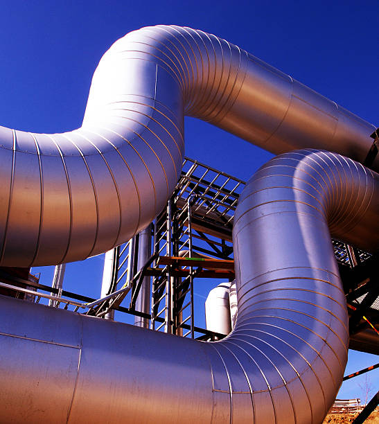 istock Industrial zone, Steel pipelines at sunset 490210846