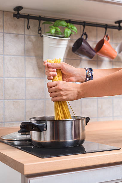 istock Woman cooking spaghetti 490211784