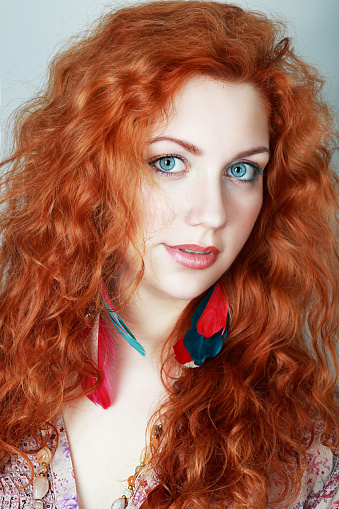 Portrait of a young woman with red hair and blue eyes