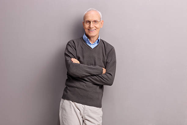 istock Cheerful senior leaning against a gray wall 490214538