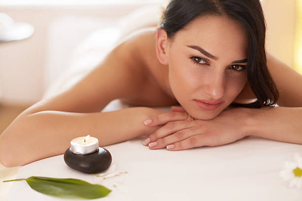 istock Spa Massage. Beautiful Brunette Gets Spa Treatment in Salon. 490214956