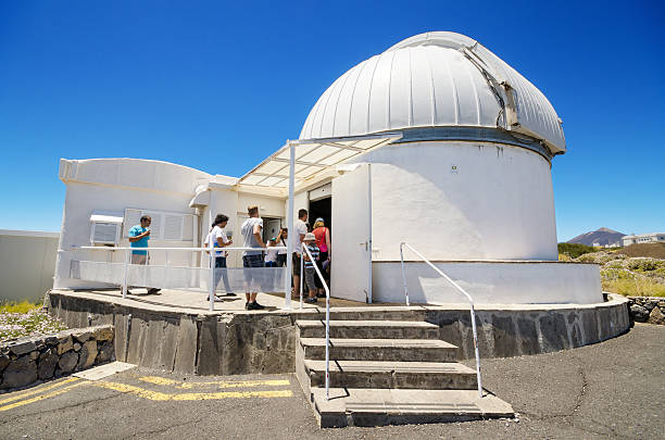 Tourist visiting a telescope in Teide astronomical Observatory Tenerife, Spain - July 7, 2015: Tourist visiting a telescope on July 7, 2015 in Teide astronomical Observatory, Tenerife, Canary Island, Spain. observatory tenerife canary islands el teide national park stock pictures, royalty-free photos & images
