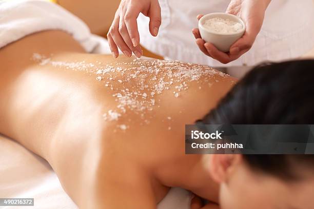 Spa Woman Brunette Getting A Salt Scrub Beauty Treatment Stock Photo - Download Image Now