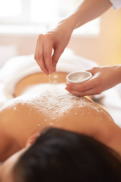 istock Spa Woman. Brunette Getting a Salt Scrub Beauty Treatment 490216462