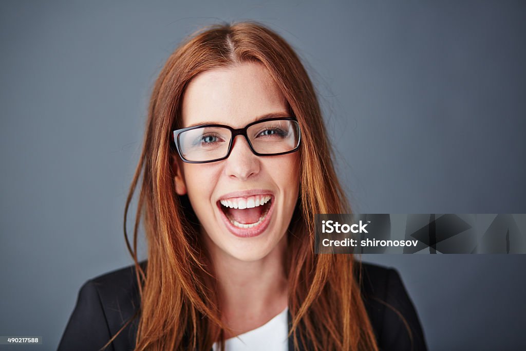 Ecstatic secretary Ecstatic young businesswoman in eyeglasses looking at camera Business Person Stock Photo