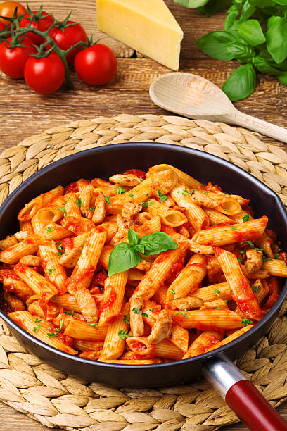istock Penne with roasted chicken in tomato sauce 490218384