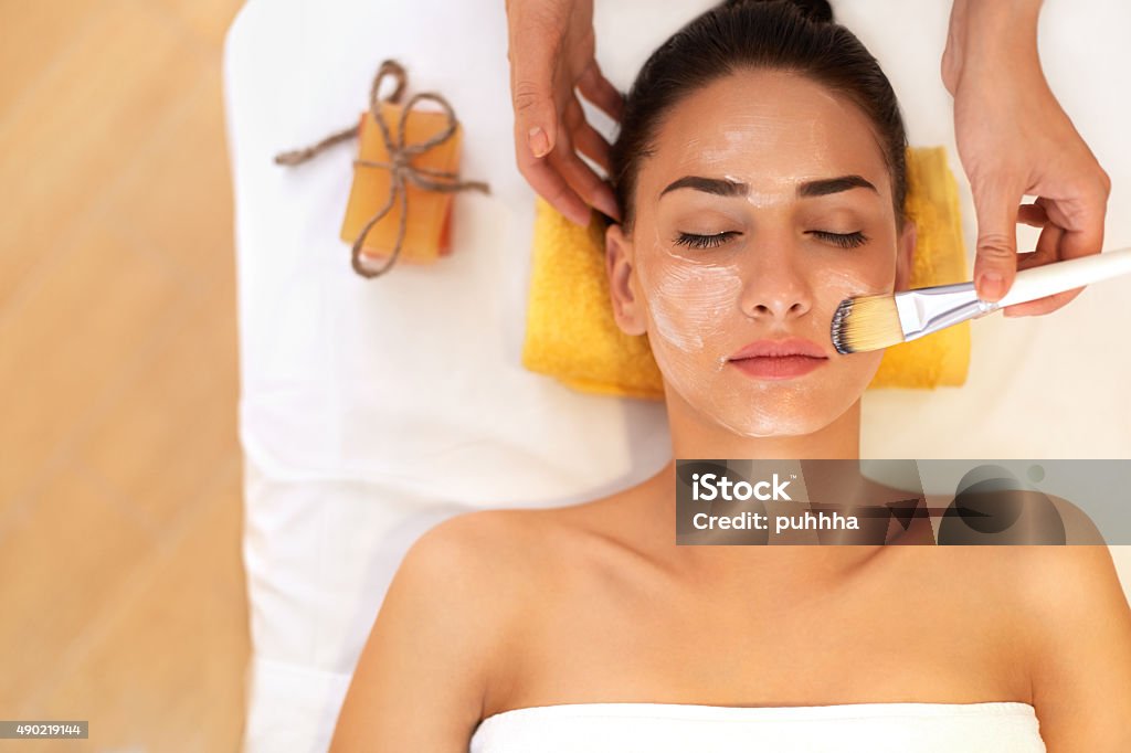 Face Treatment. Woman in Beauty Salon Gets Marine Mask Facial Mask - Beauty Product Stock Photo