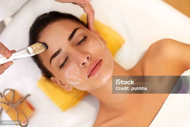 Face Treatment Woman In Beauty Salon Gets Marine Mask Stock Photo - Download Image Now