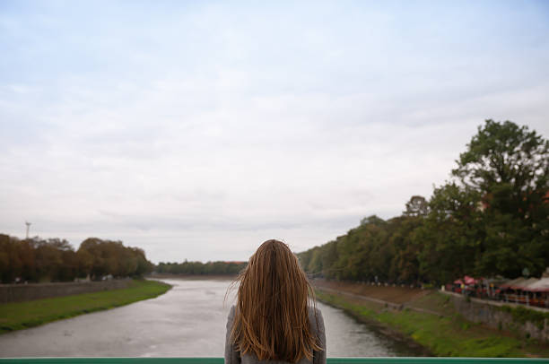 istock woman looks out over the blurred river landscape 490220104