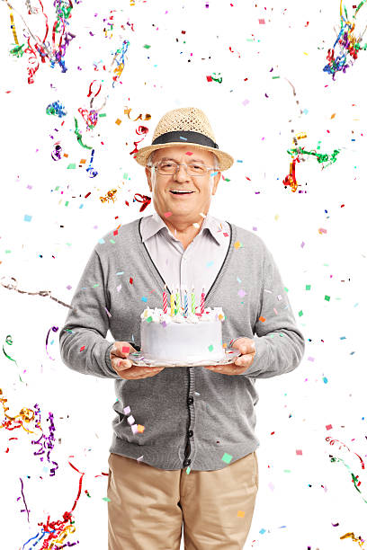 istock Senior gentleman carrying a birthday cake 490220366