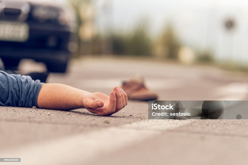 Car hit scene Car hit scene, male person lying on the floor in front of a car Misfortune Stock Photo