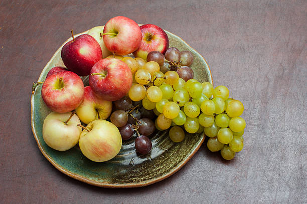 istock Plate with fresh autumnal fruits, apples and grapes 490220876