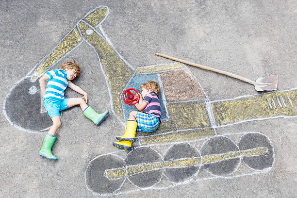 istock Two little kid boys with excavator chalk picture 490221776
