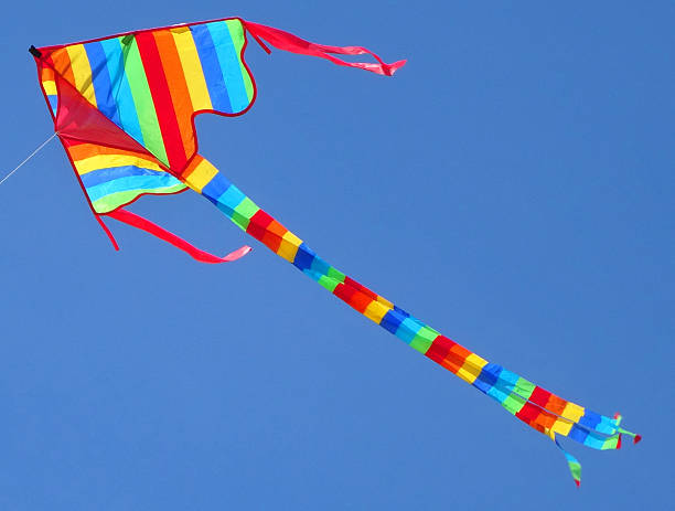 istock Image of arrowhead kite flying in sky with rainbow stripes 490222158