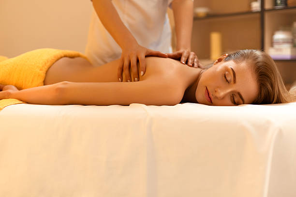 istock Spa Massage. Beautiful Blonde Gets Spa Treatment in Salon. 490222830