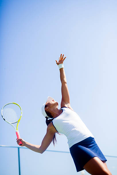 istock Beautiful female tennis player serving 490222902