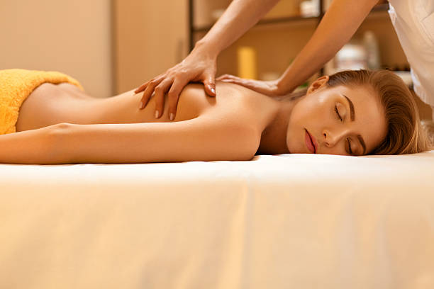 istock Spa Massage. Beautiful Blonde Gets Spa Treatment in Salon. 490222920