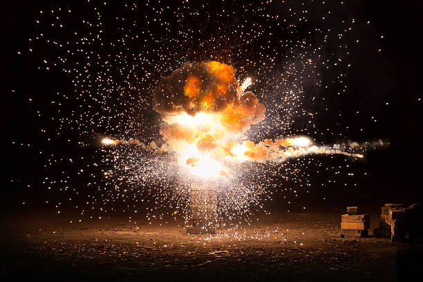 Realistic fiery explosion busting over a black background Realistic fiery explosion busting over a black background explosive stock pictures, royalty-free photos & images