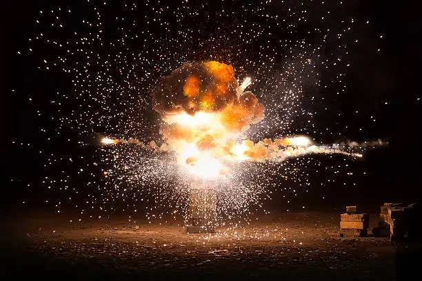 Photo of Realistic fiery explosion busting over a black background