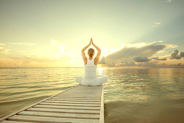 istock Caucasian woman practicing yoga at seashore 490225220