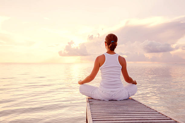 istock Caucasian woman practicing yoga at seashore 490225248