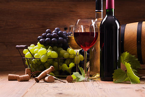 istock Glasses of red and white wine, served with grapes 490225990