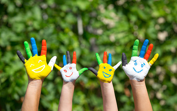 istock Colored hands with smile painted in colorful paints against gree 490238300