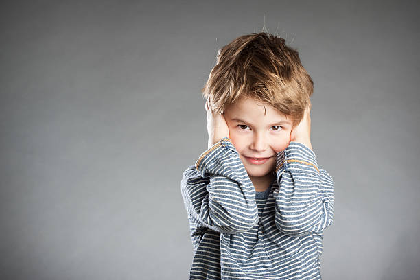 istock Portrait of boy, hear no evil, grey background 490238488
