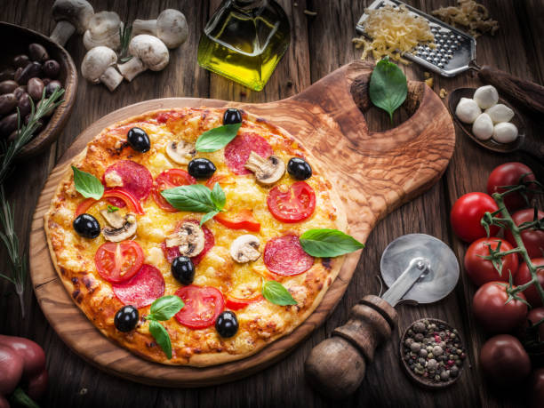 istock Pizza with mushrooms, salami and tomatoes. 490239630