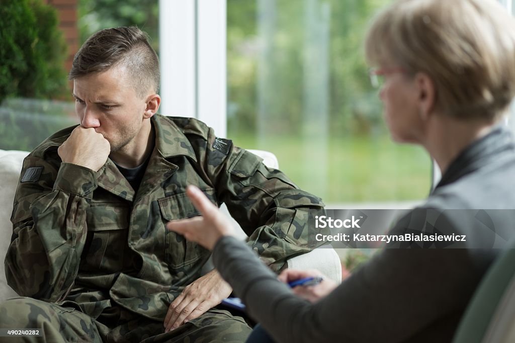 War veteran with problems War veteran talking about problems during therapy Military Stock Photo