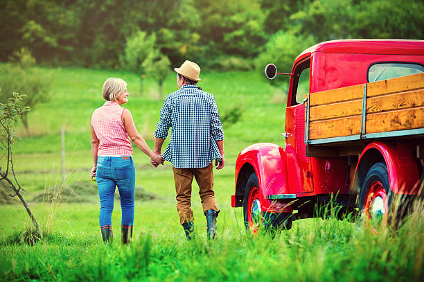 coppia con camion rosso - action mature couple senior adult mature adult foto e immagini stock