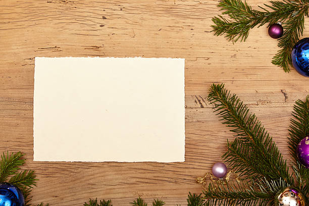 istock Fir twigs, baubles and blank card on wood 490240666