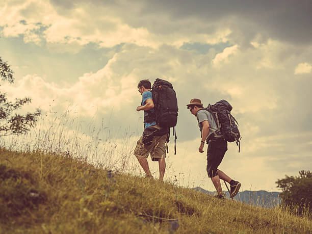 istock two friends hiking on hill 490241424