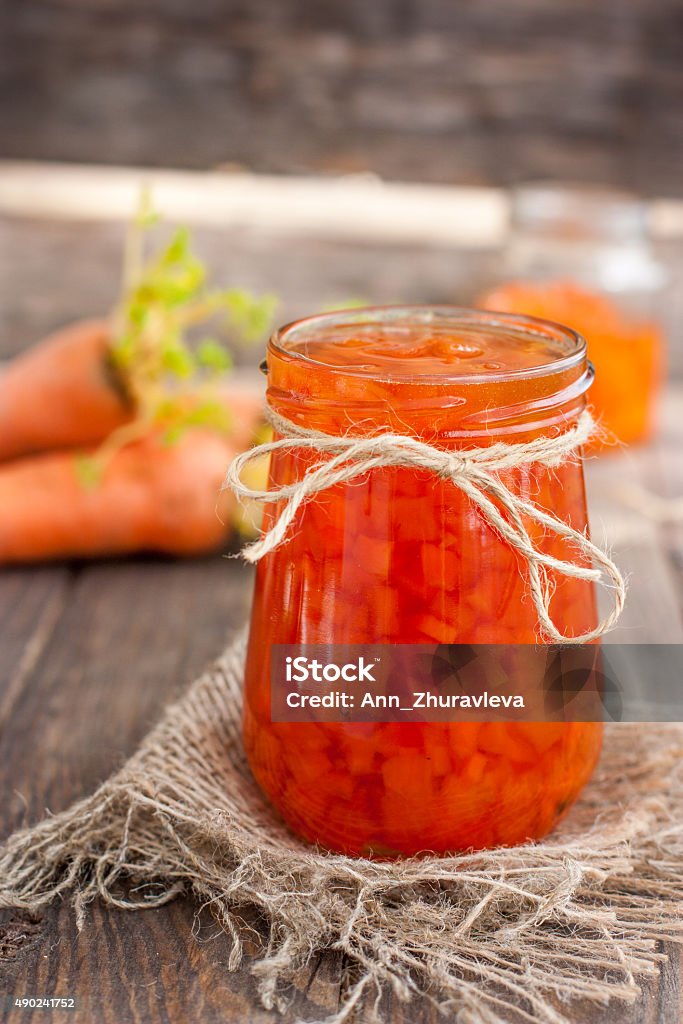 Jam of carrots Carrot jam in a glass jar on a wooden table 2015 Stock Photo