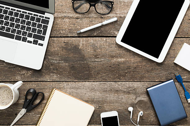 istock Grunge hipster wooden desktop with computer, digital tablet 490242420