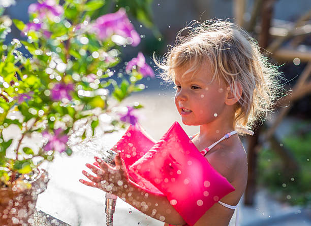 istock Cute blonde gardening on sunny day 490242694