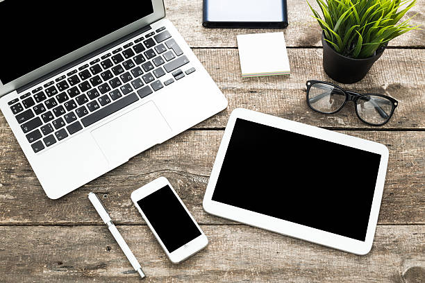 istock Grunge hipster wooden desktop with computer, digital tablet 490243118