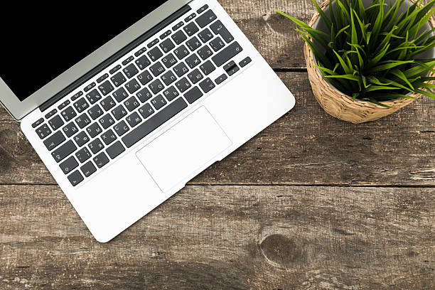 istock Grunge hipster wooden desktop with computer, digital tablet 490243866