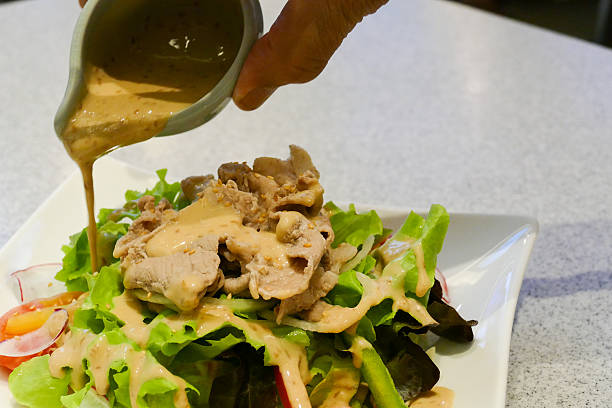 istock pork and mix vegetable salad with japanese salad dressing 490246818