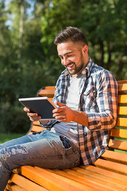 istock Young man working on tablet PC outdoors 490249352
