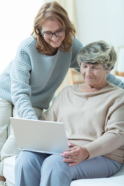 istock Carer teaching old woman 490251644