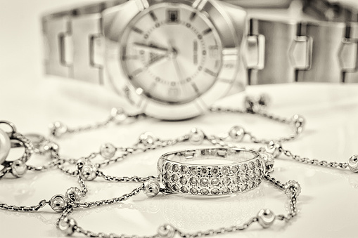 Silver ring and chain on the background of women's watches