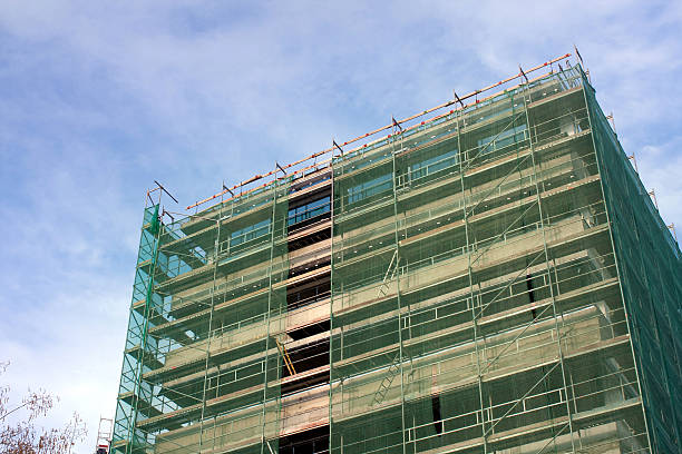 istock Staircase and scaffolding on a construction site,covered with mesh. 490260773