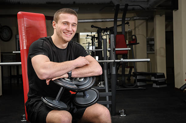 istock young man sits after workout in gym 490261603