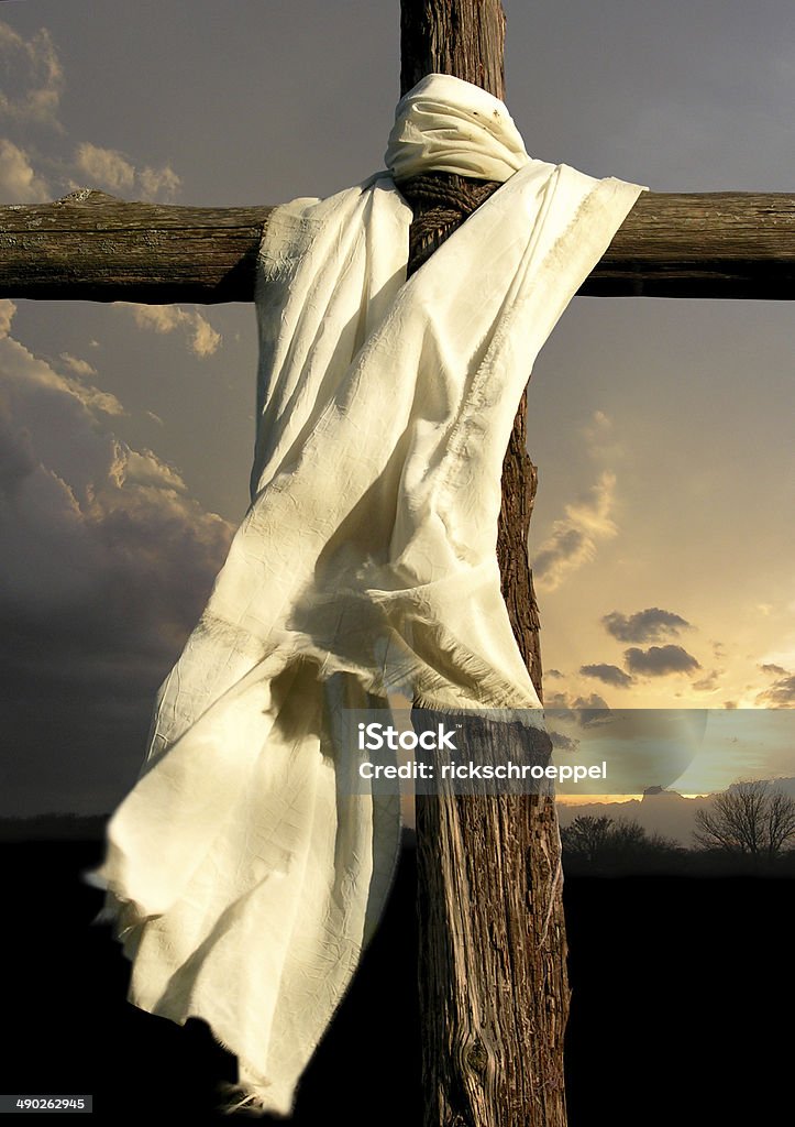 Cross and Garment The cross of Jesus as described in the Bible is shown in closeup, with moody sky in the background. Free of Charge Stock Photo