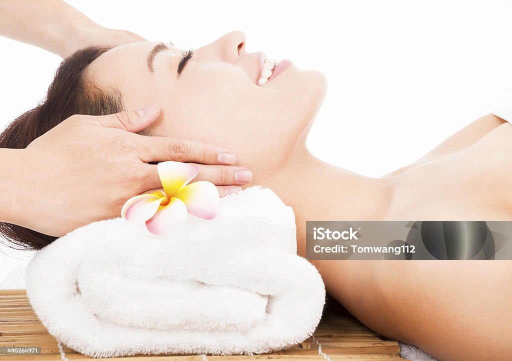 relaxing massage of face for woman in spa salon relaxing massage of face for asian woman in spa salon Massaging Stock Photo