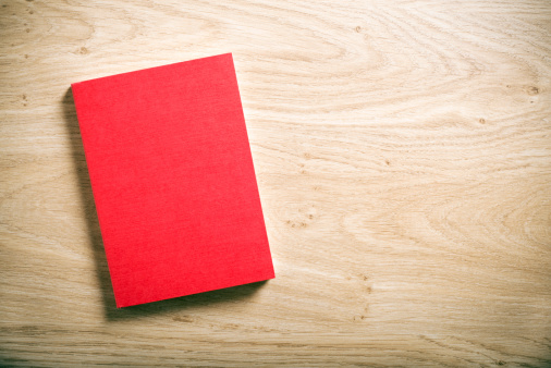 red book with blank cover on the table