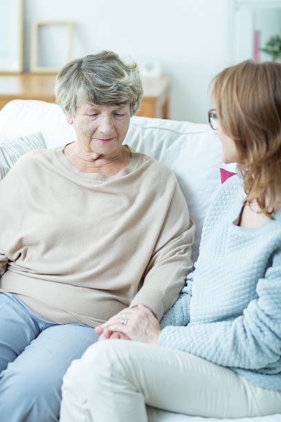 istock Female senior talking with caregiver 490272798