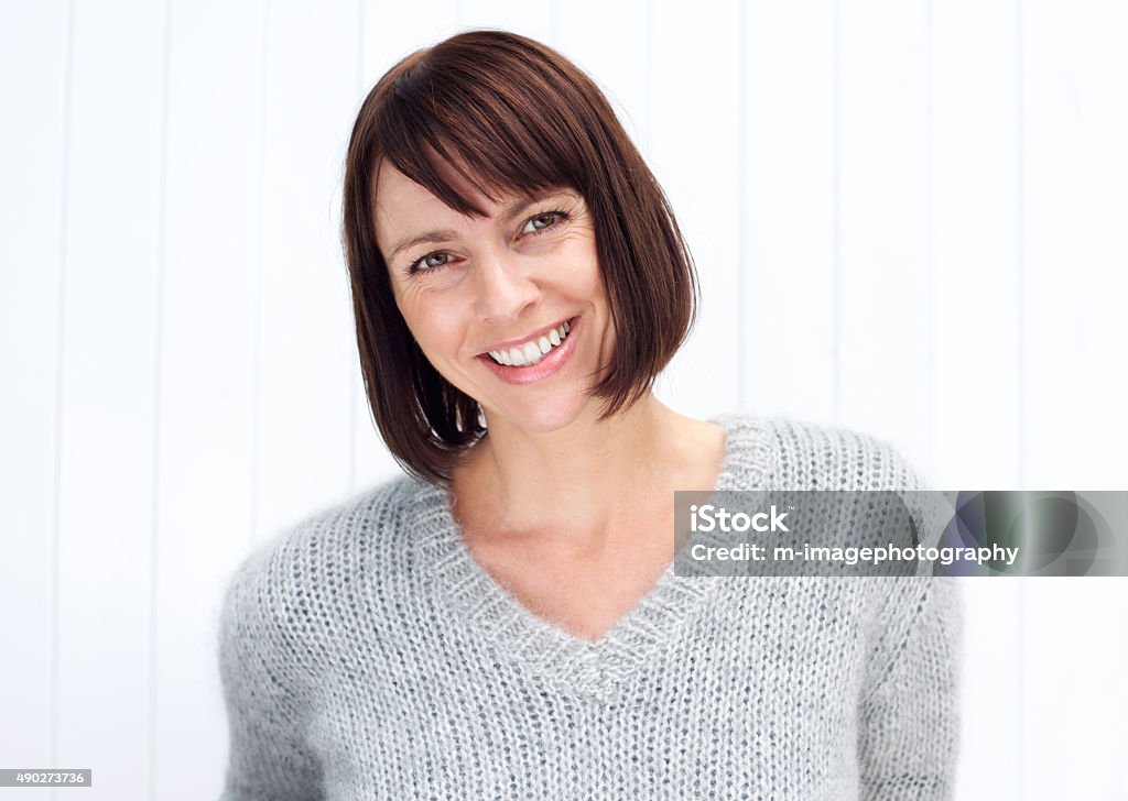 Attractive older woman smiling Close up portrait of an attractive older woman smiling against white background Mature Women Stock Photo