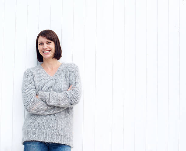 istock Mature woman smiling against white wall 490277484